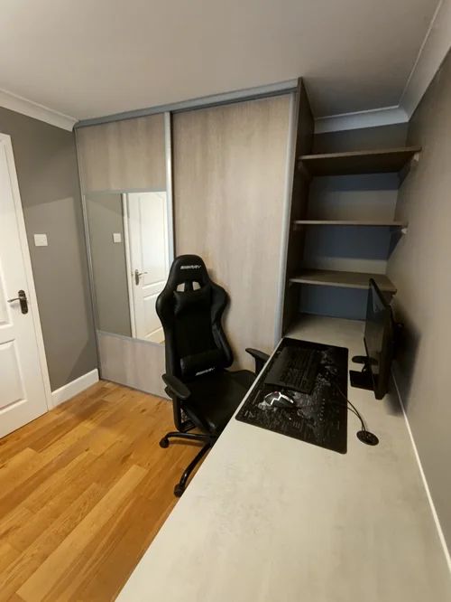 Home office with fitted sliding wardrobe, shelving and desk